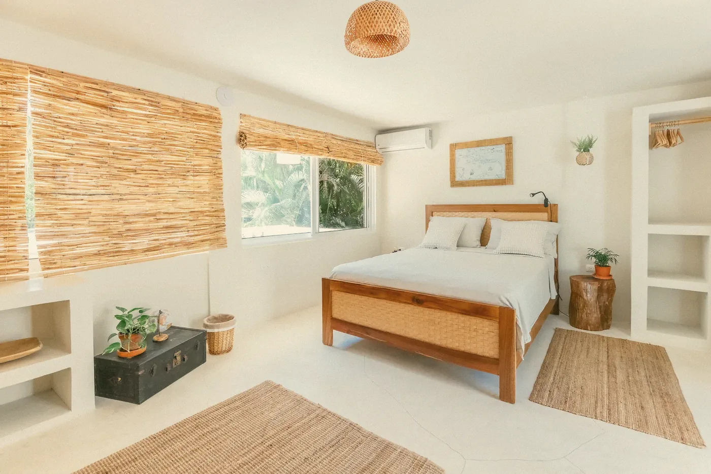 A bedroom with a wooden bed and bamboo blinds