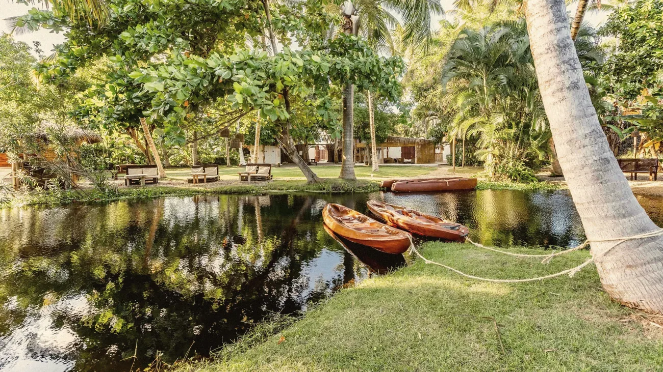 Kayaks on the bank of the lagoon at Kibayo