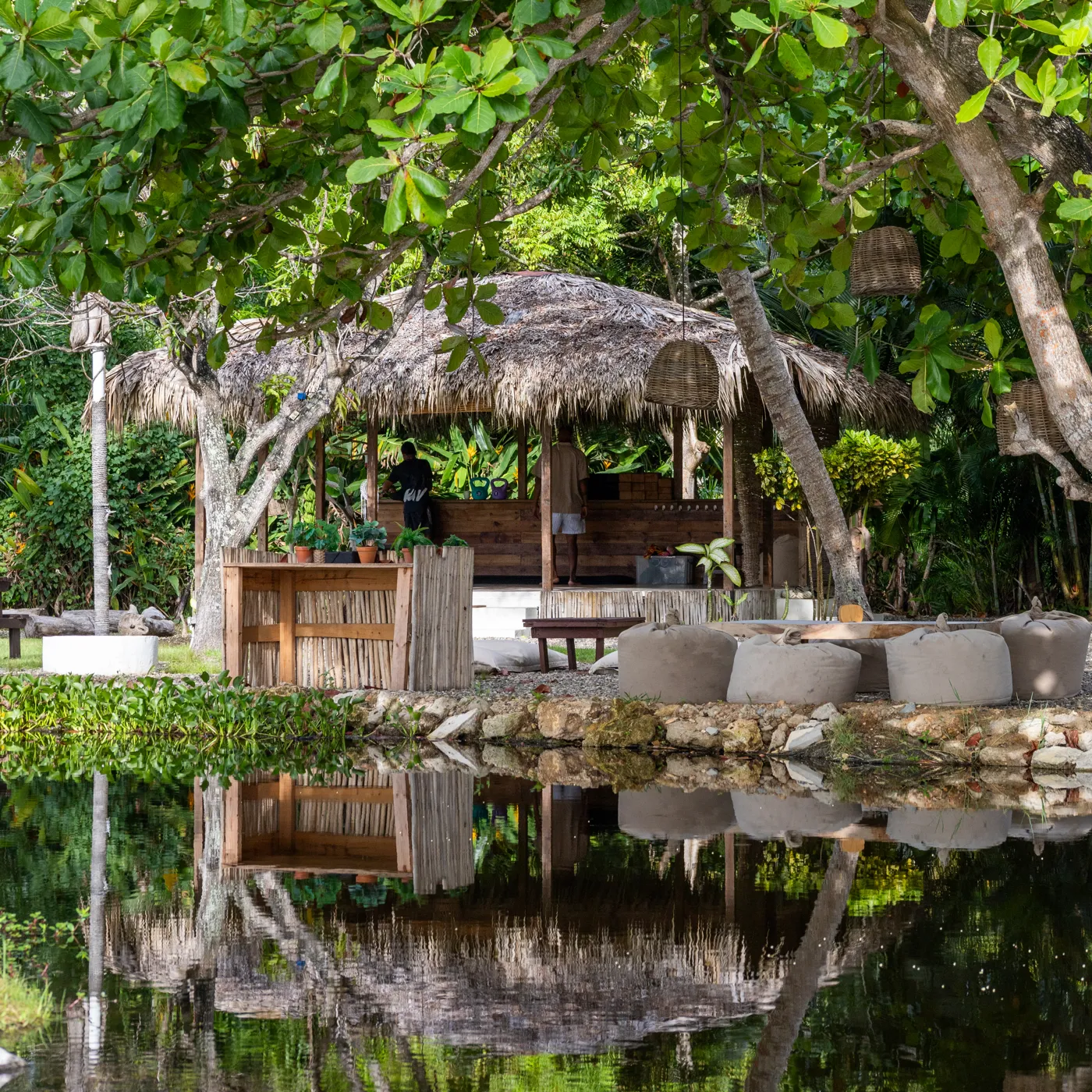 The shala reflected in the lagoon